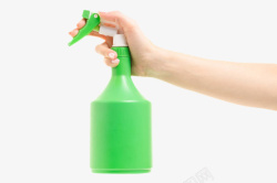 喷雾容器手指按压着绿色喷壶实物高清图片