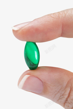 绿色药片绿色胶囊治愈手捏着的西药片实物高清图片