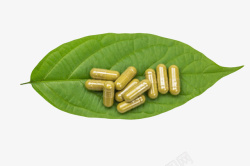 绿色药片棕色治愈绿色叶子上的西药片实物高清图片