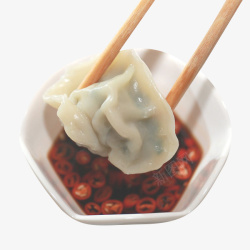 小吃锅贴蘸辣酱的煎饺高清图片