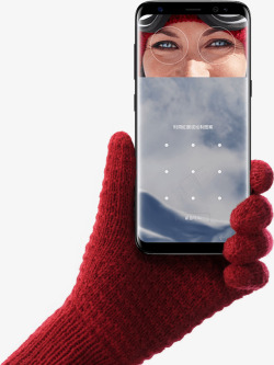 holdingHand wearing glove holding up Galaxy S8 for iris scanning手机高清图片