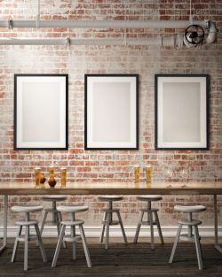 空白磁砖墙桌椅与墙上的空白画框高清图片