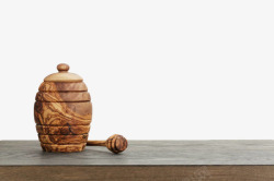 木制罐子桌子上的蜂蜜木罐高清图片