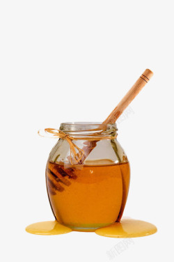 搅拌蜂蜜的木棒玻璃瓶里的蜂蜜高清图片
