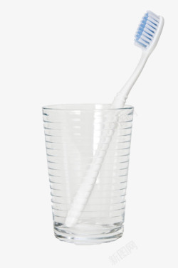 玻璃杯具白色杯子里的白色牙刷实物高清图片