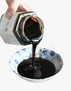 黑色梨汁瓶装倒出的梨膏高清图片